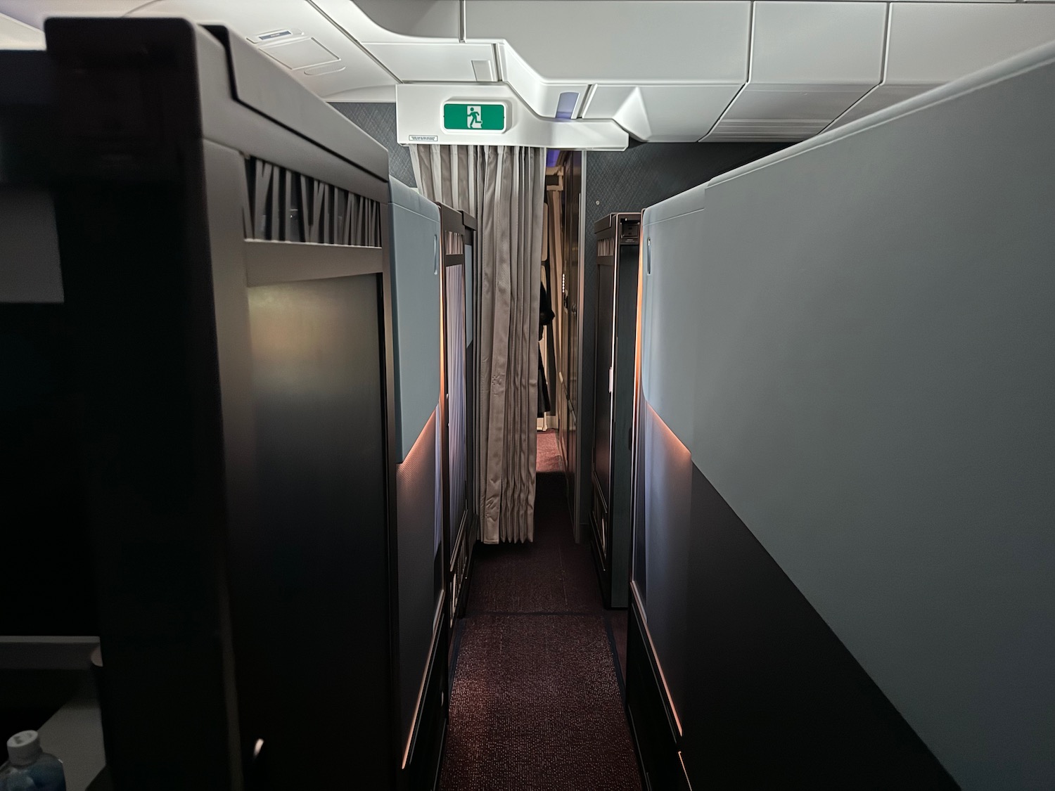 a hallway with black cabinets and a white sign