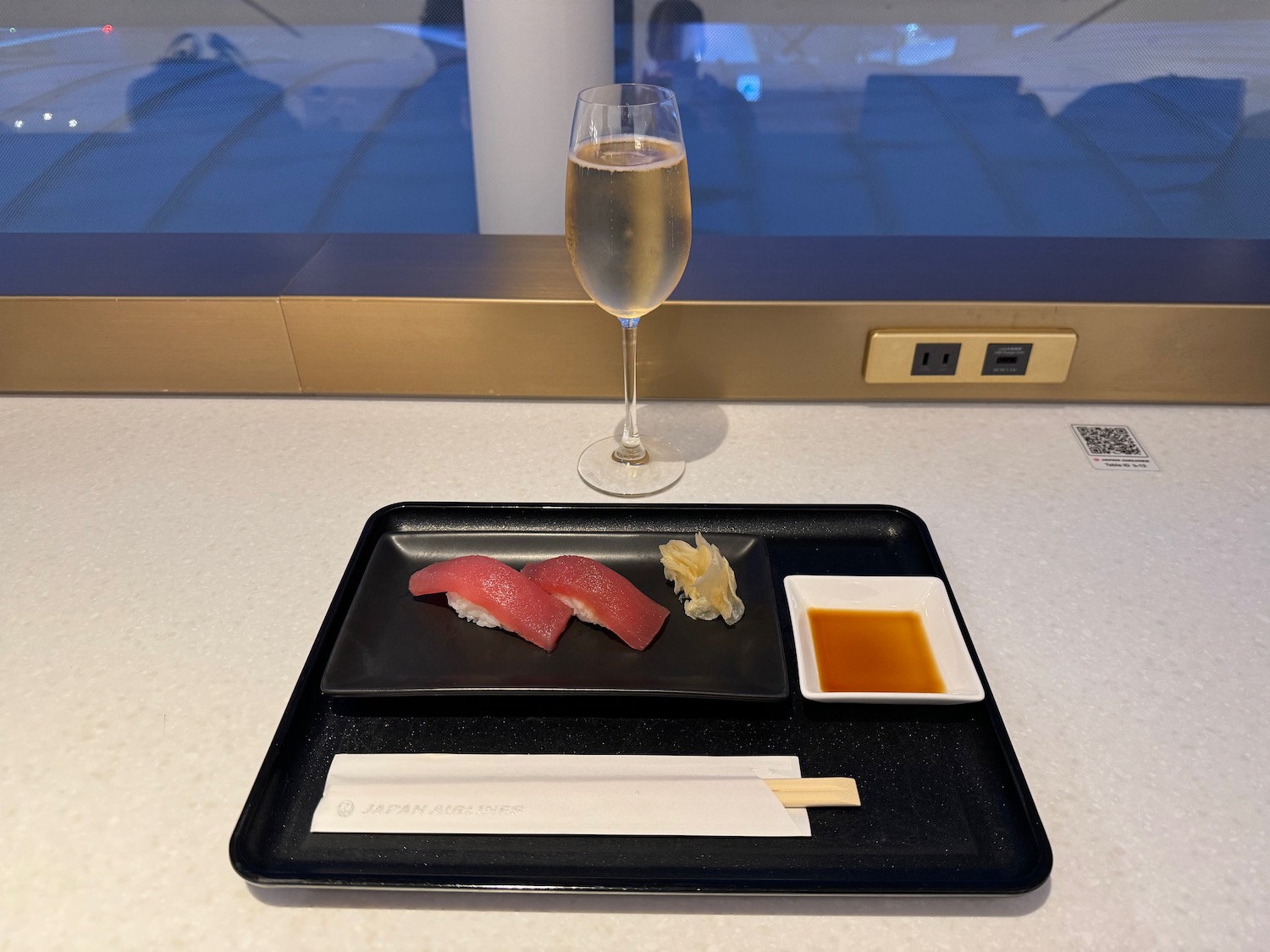 a plate of sushi and a glass of wine