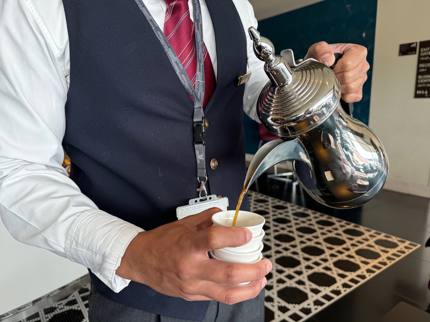 a person pouring liquid into a cup