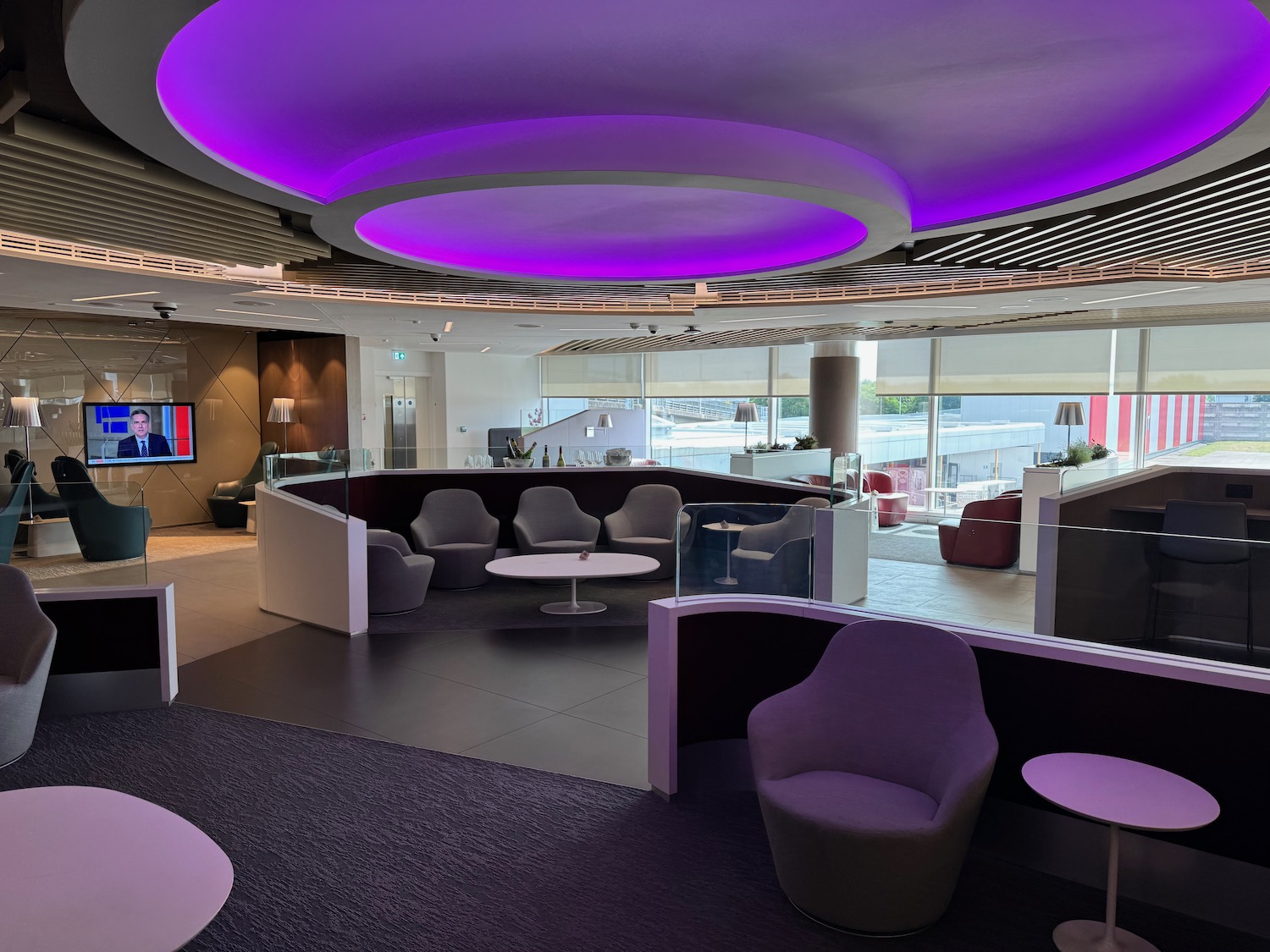 a room with purple lights and chairs