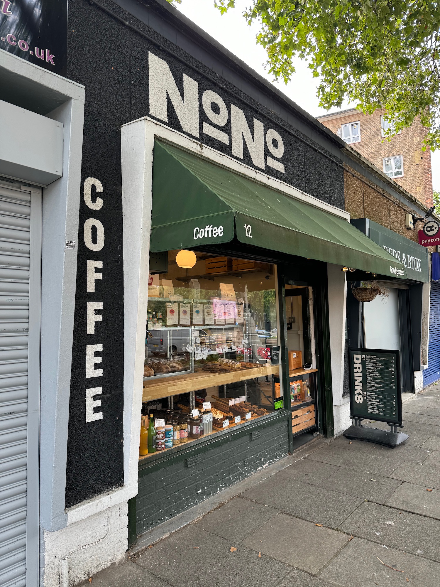 a store front with a green awning