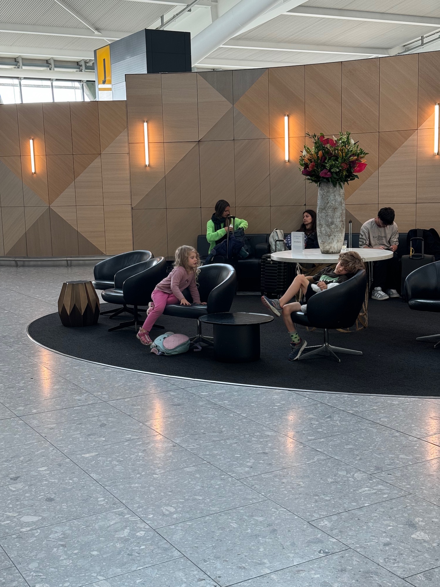 a group of people sitting in chairs in a lobby