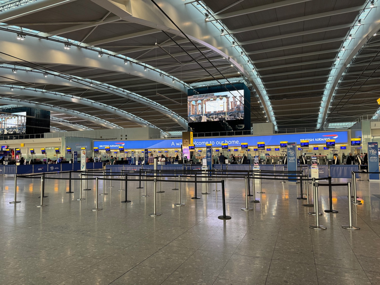 a large airport with people waiting for their flight