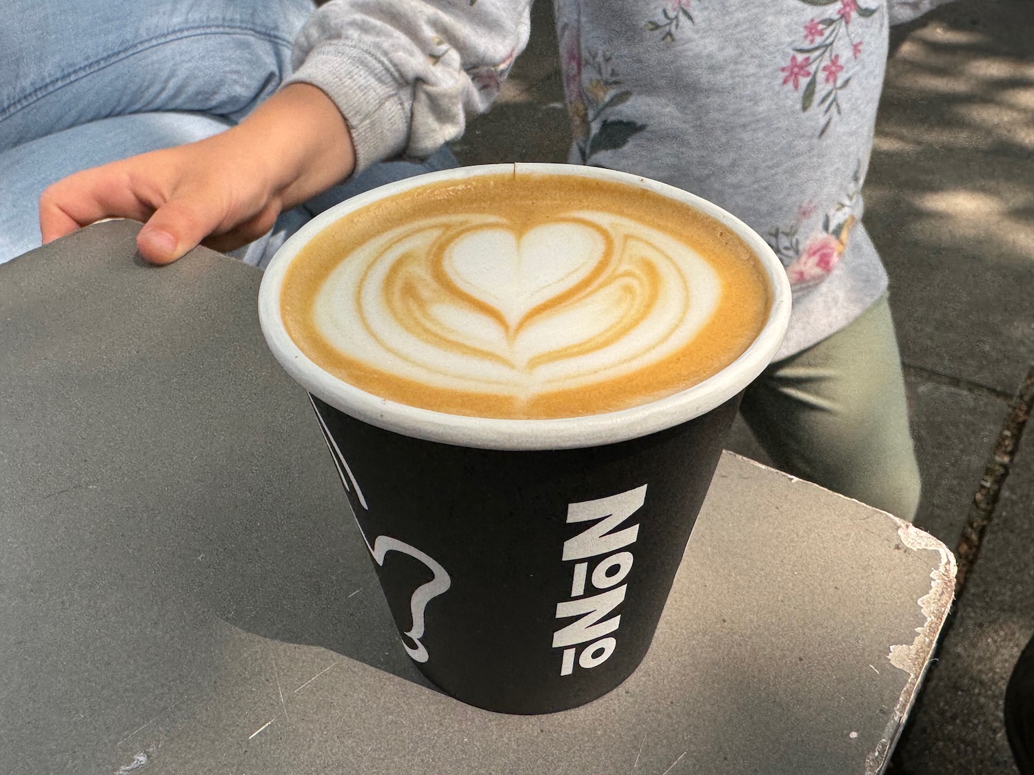 a cup of coffee with a heart shaped foam