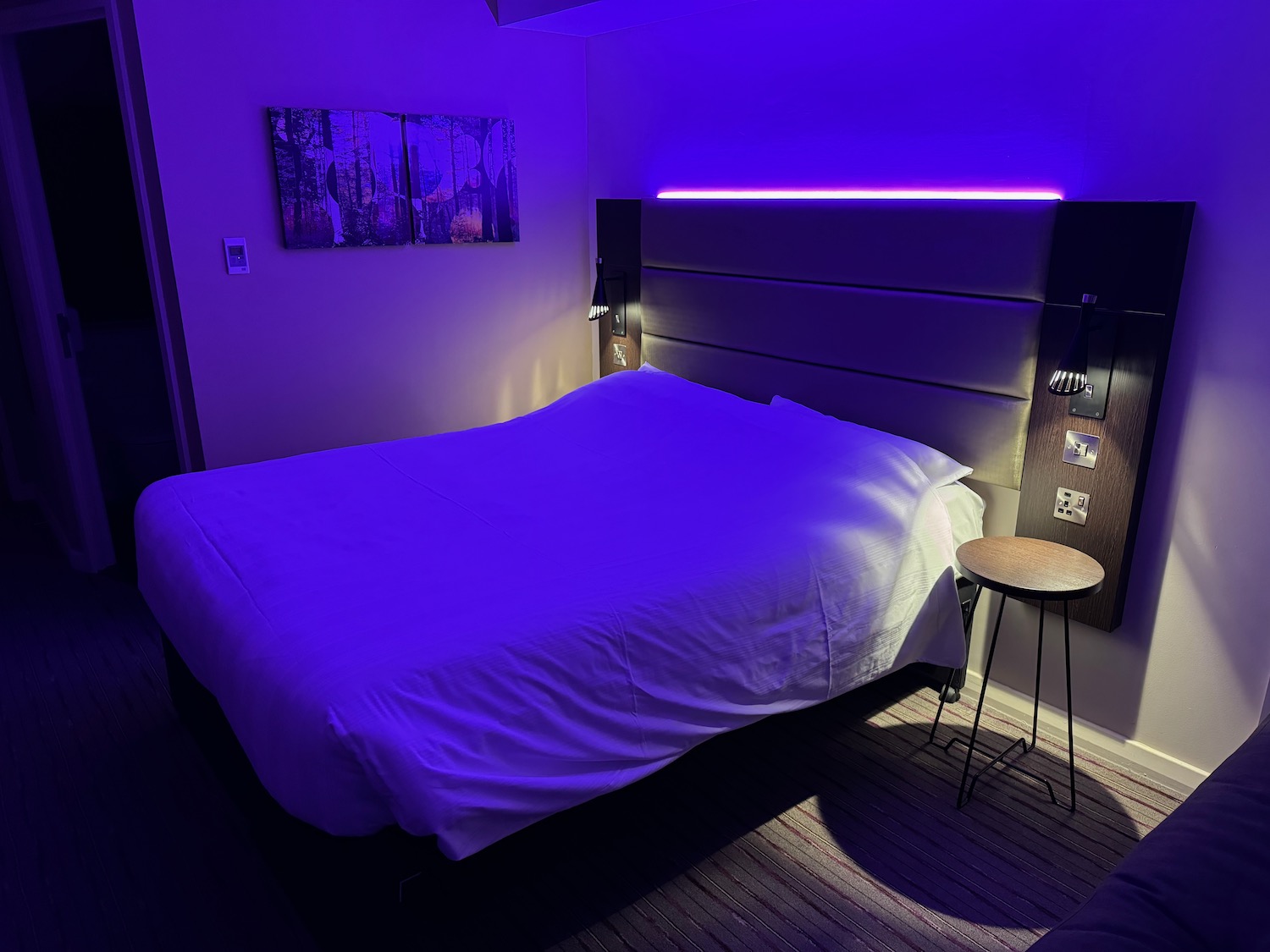 a bed with purple lighting