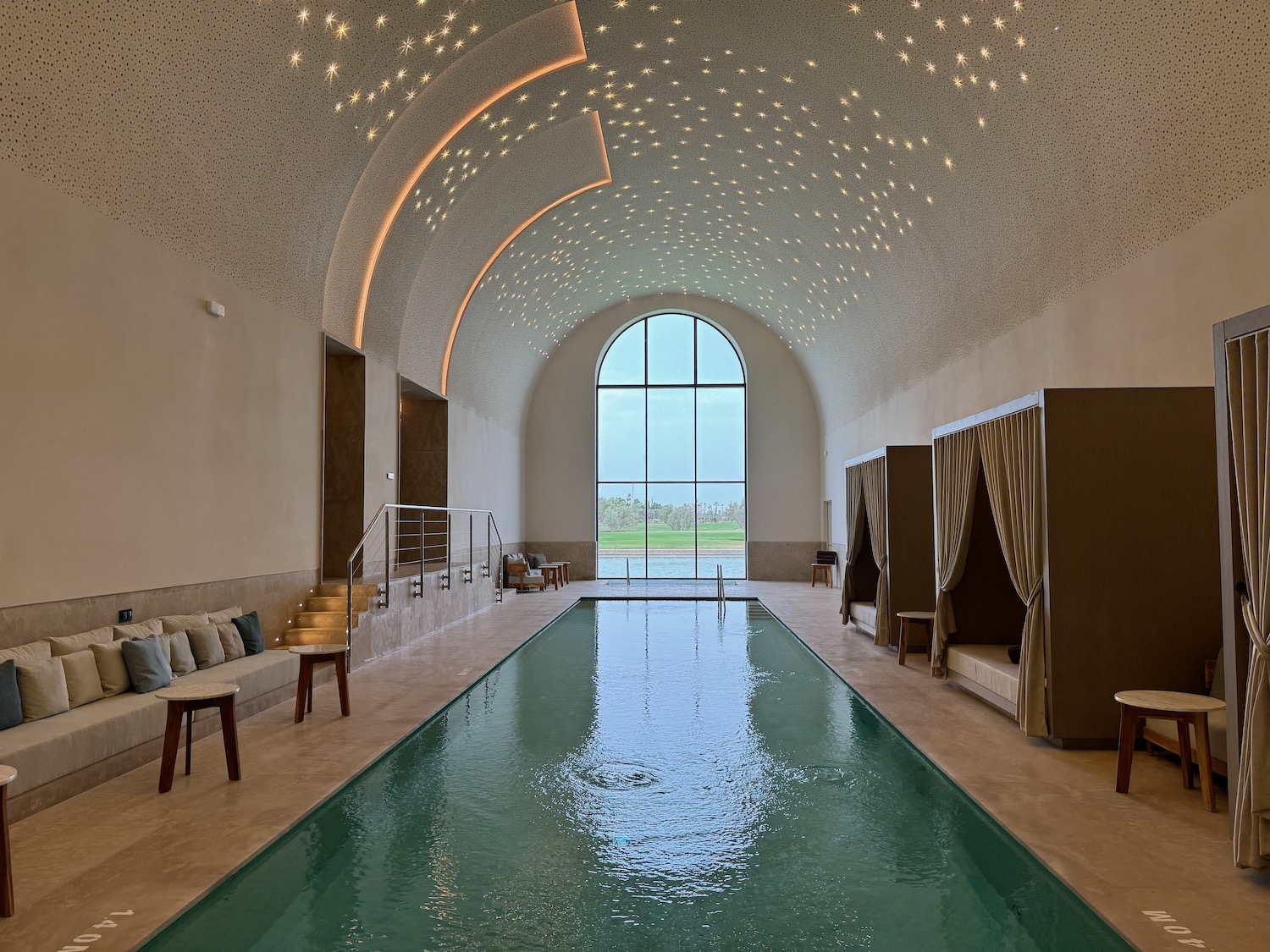 an indoor pool with a large vaulted ceiling