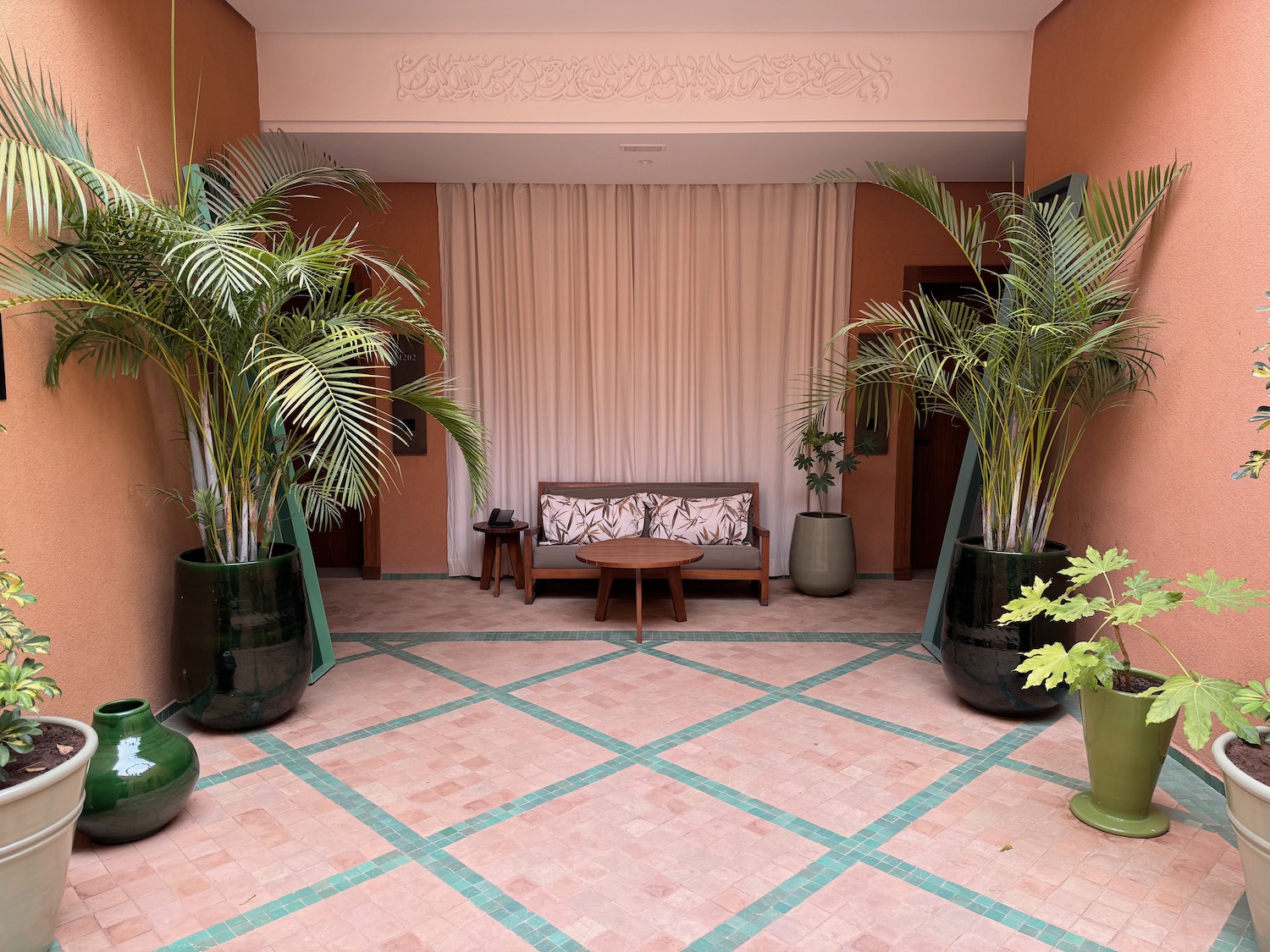 a room with a couch and potted plants