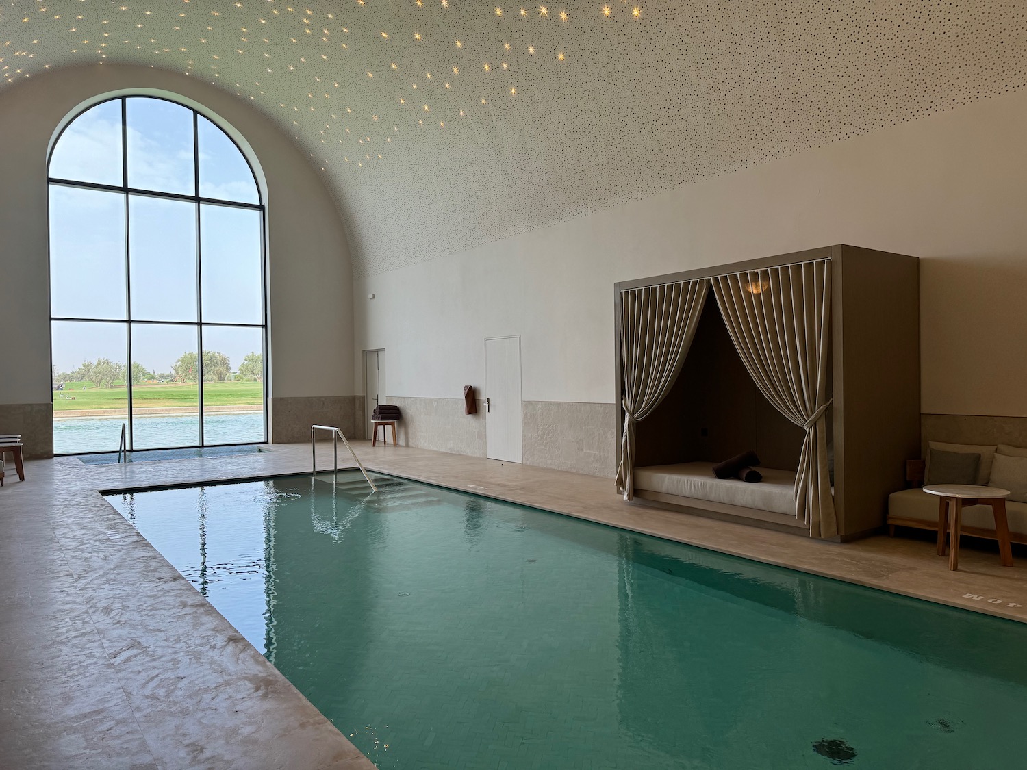 an indoor pool with a large window