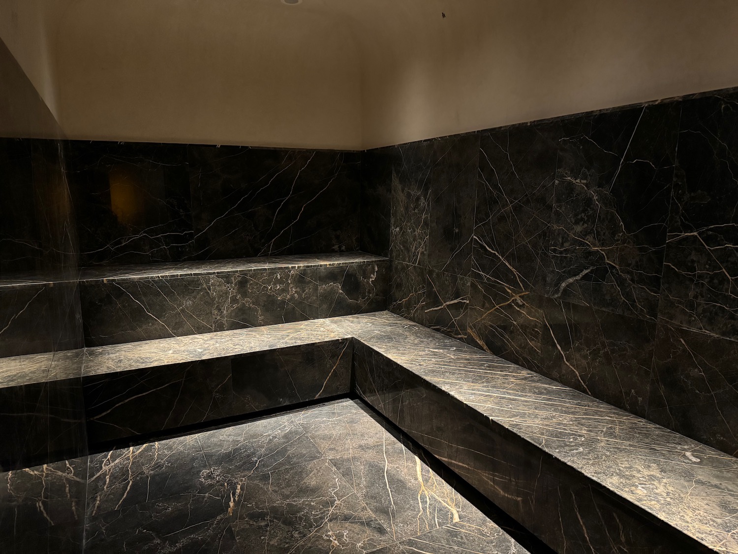 a black marble bench in a room