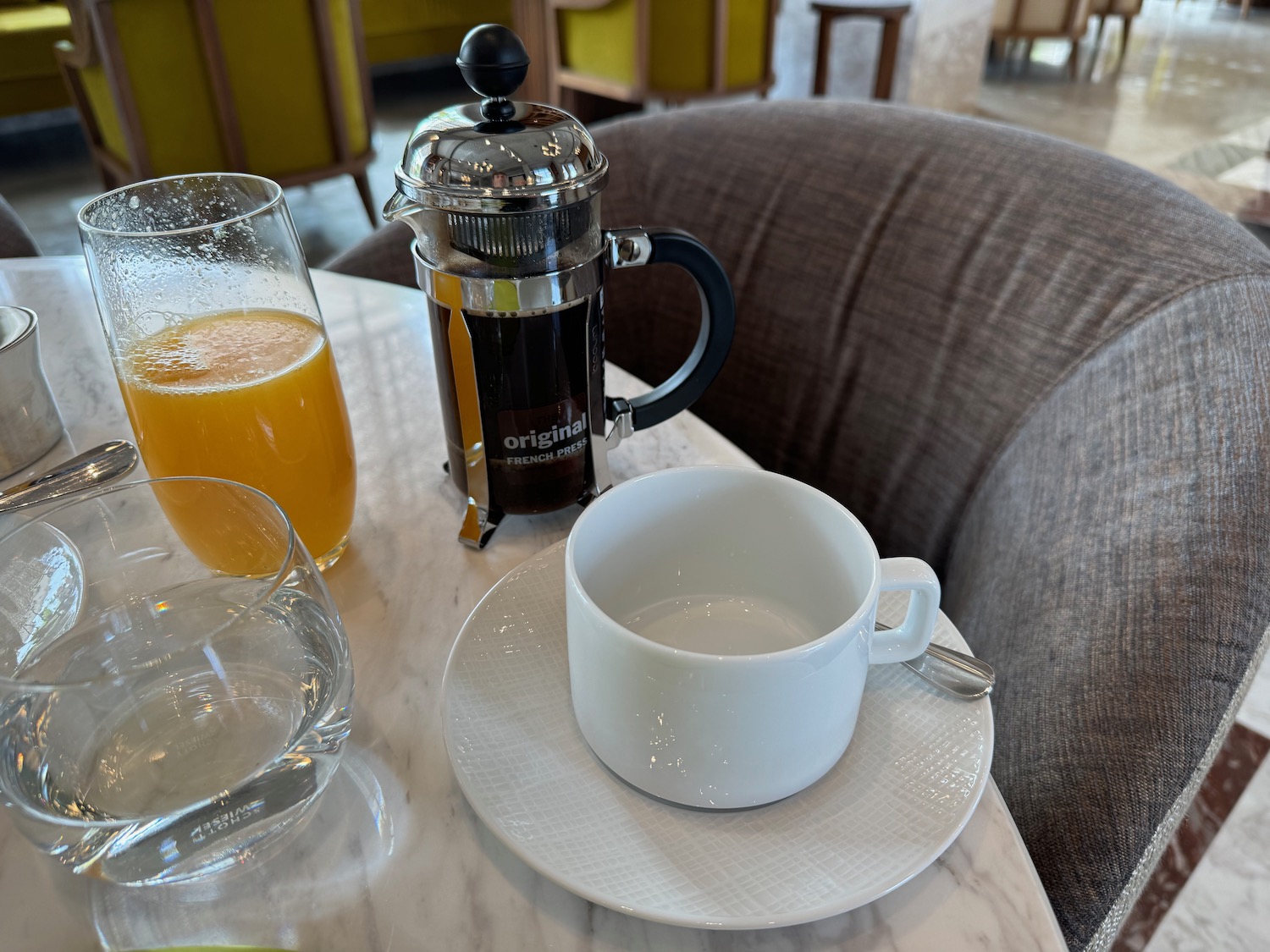 a coffee pot and a cup on a table