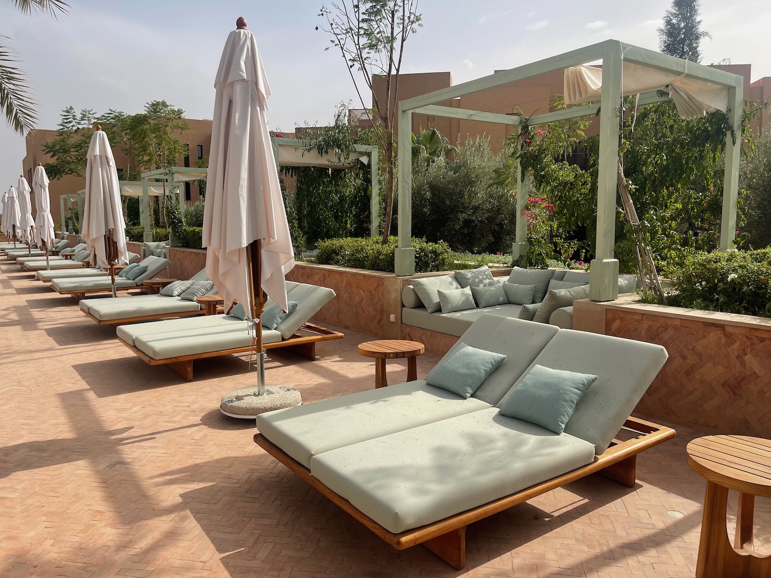 a group of deck chairs and parasols on a terrace