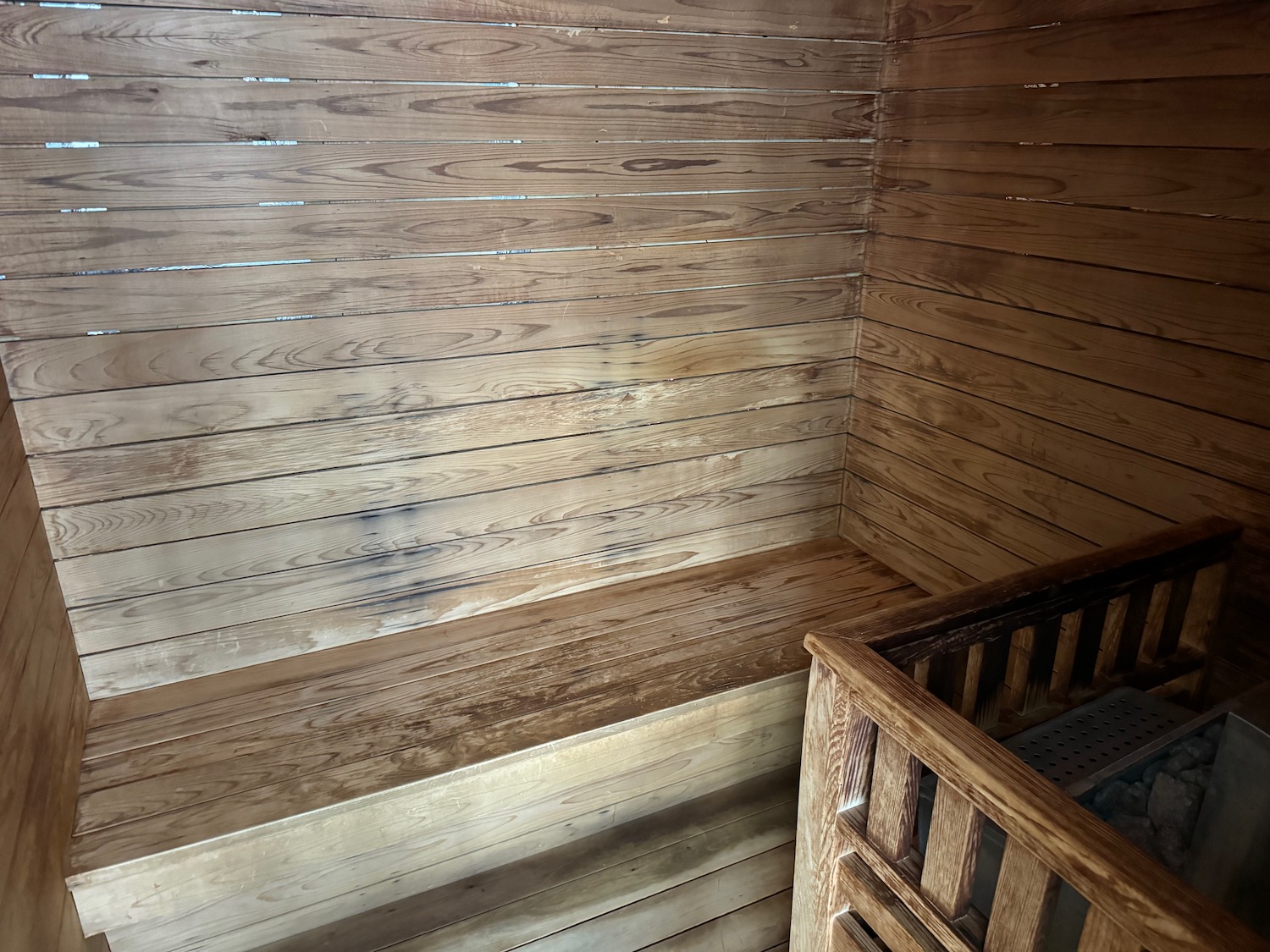 a wooden room with a cot