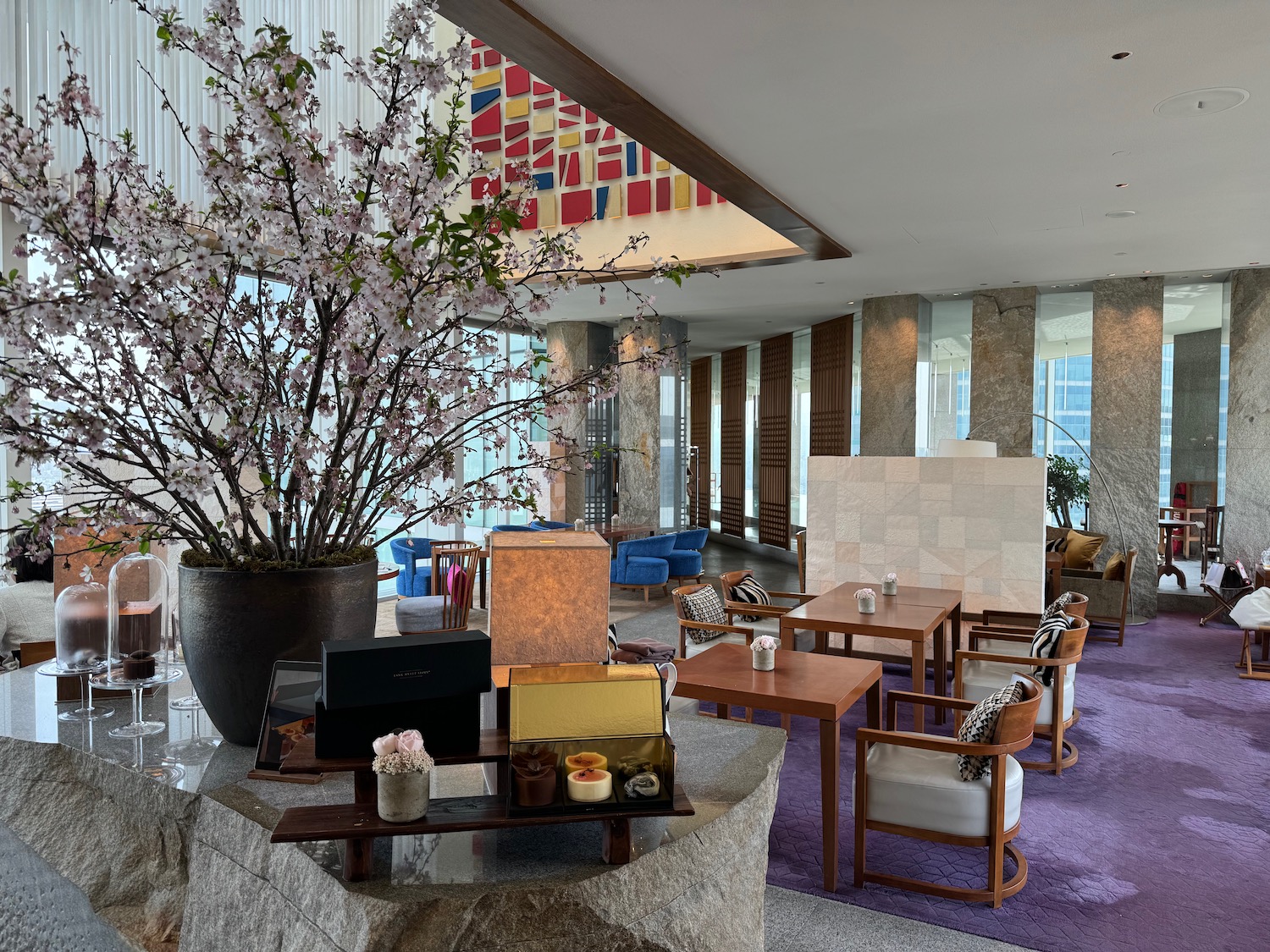 a room with a large flowerpot and tables