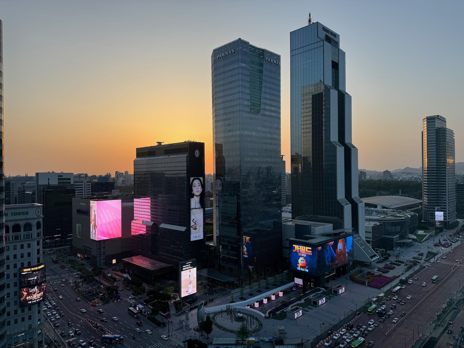 a city with tall buildings and cars