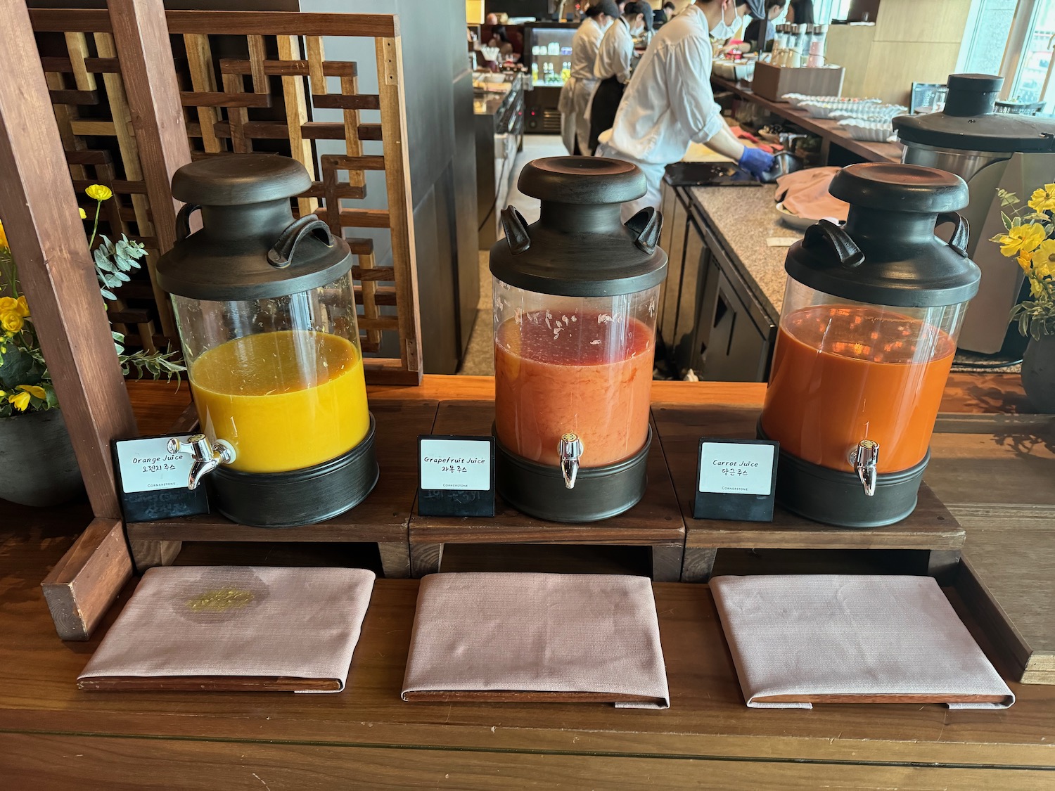 a row of juice dispensers on a table