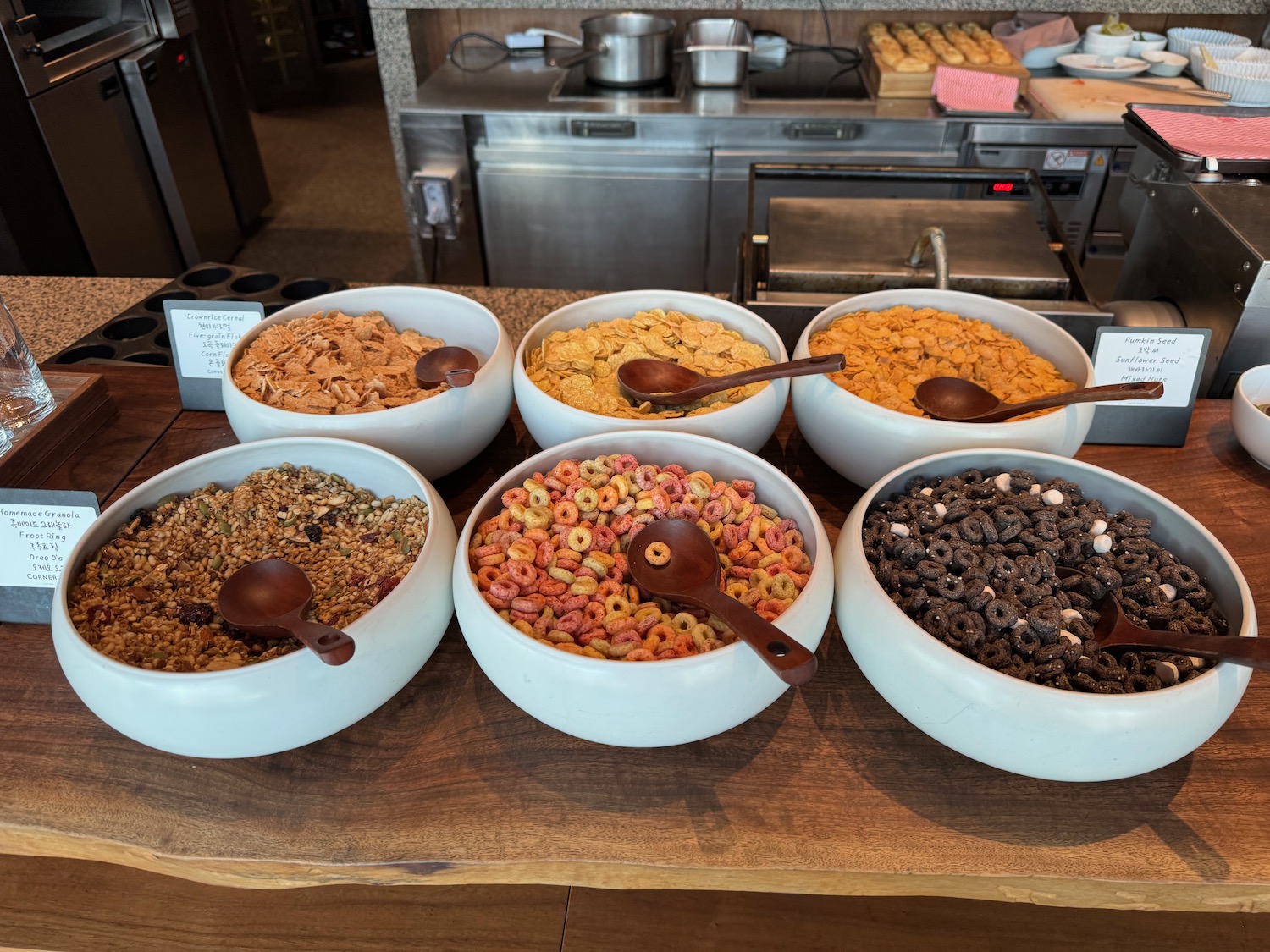 a group of cereal bowls with spoons