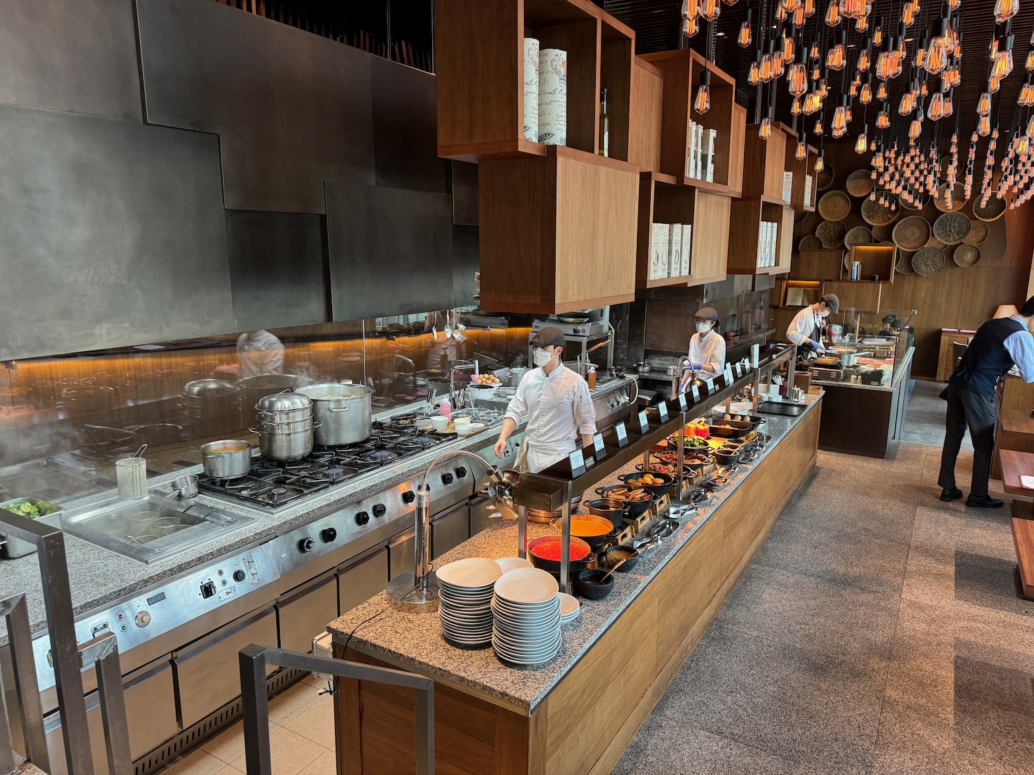 a kitchen with people cooking food