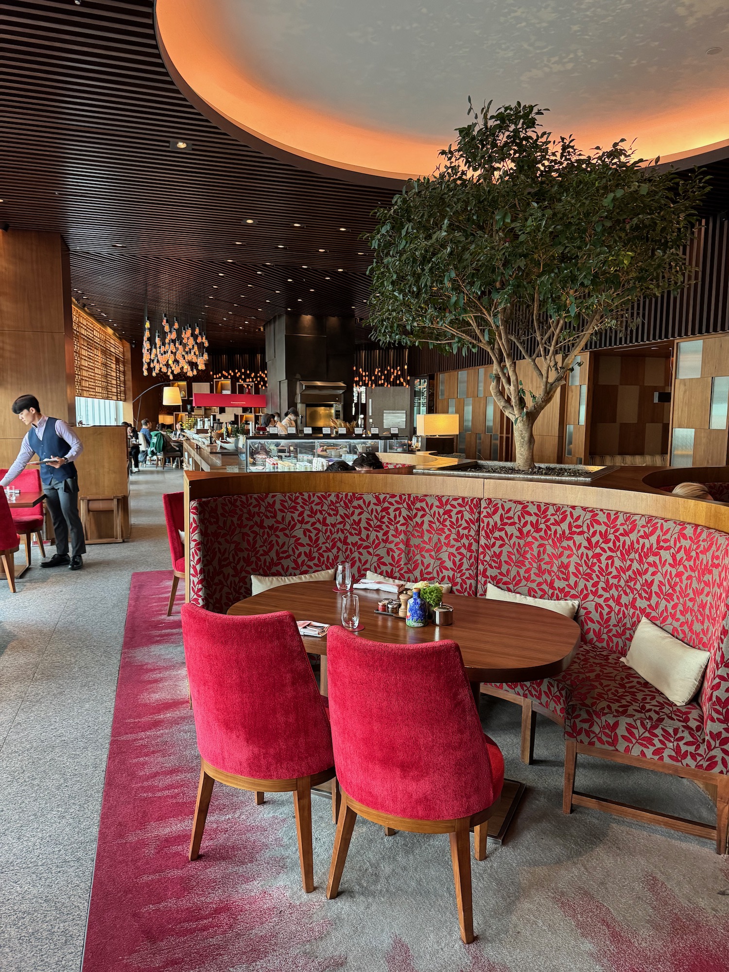 a restaurant with red chairs and tables