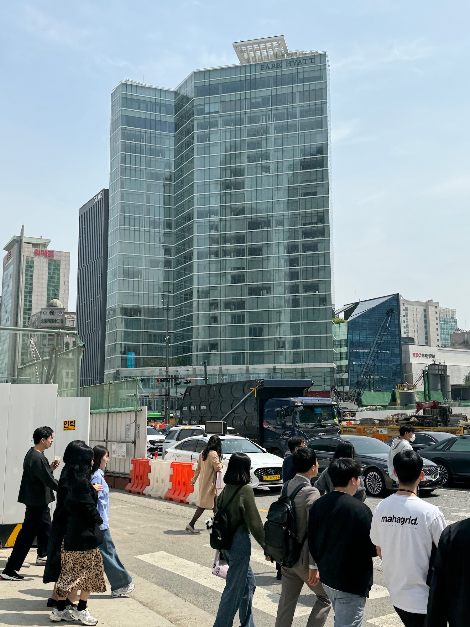 a group of people walking in front of a tall building