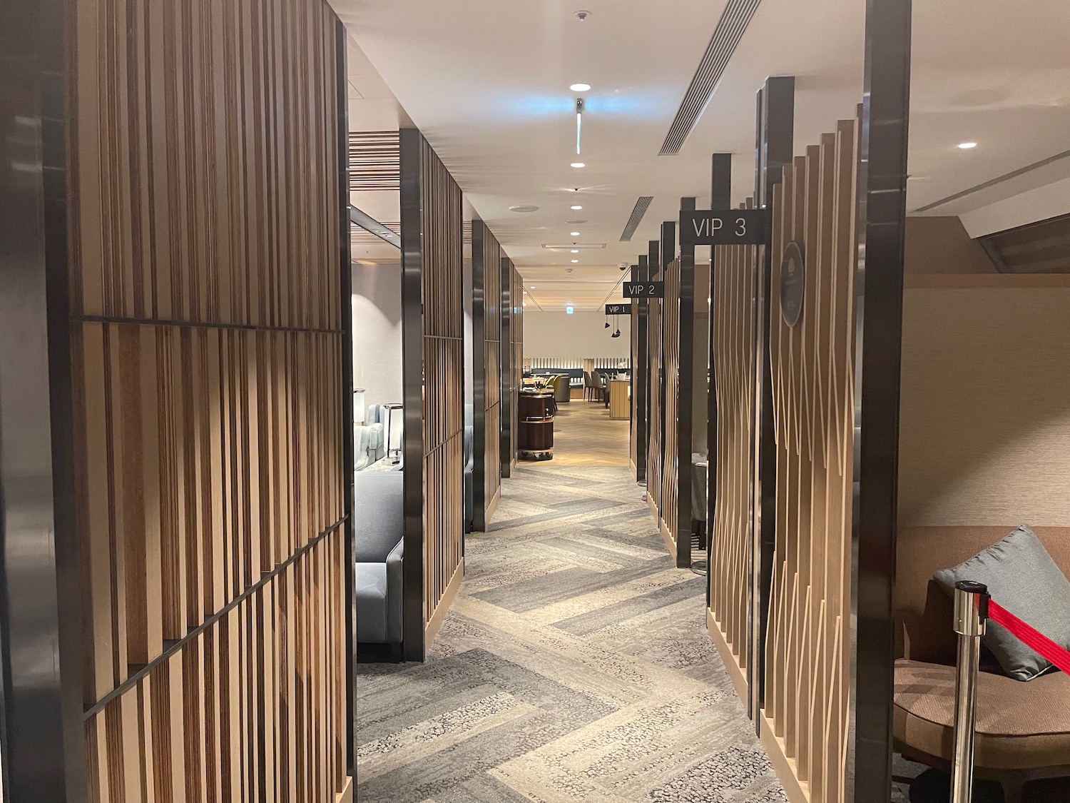 a hallway with wooden panels and a couch