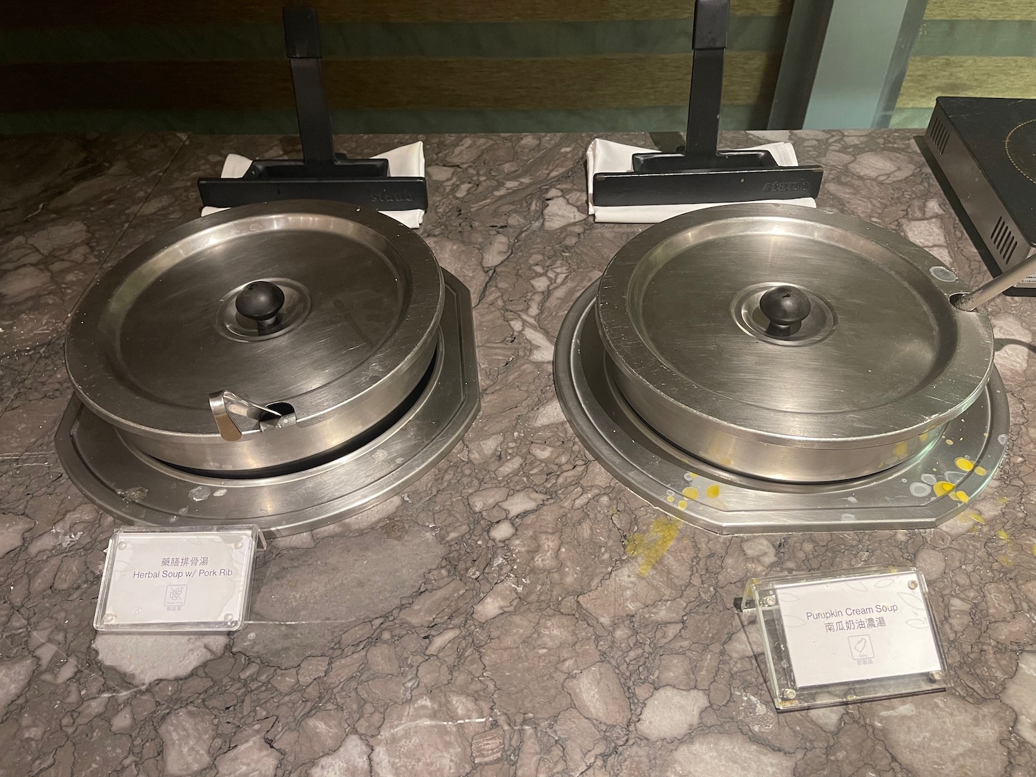 a group of metal containers on a marble table