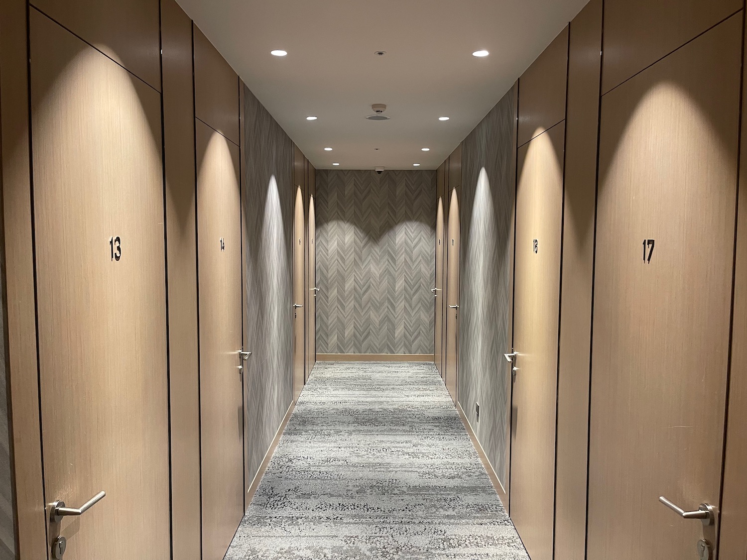 a hallway with doors and lights