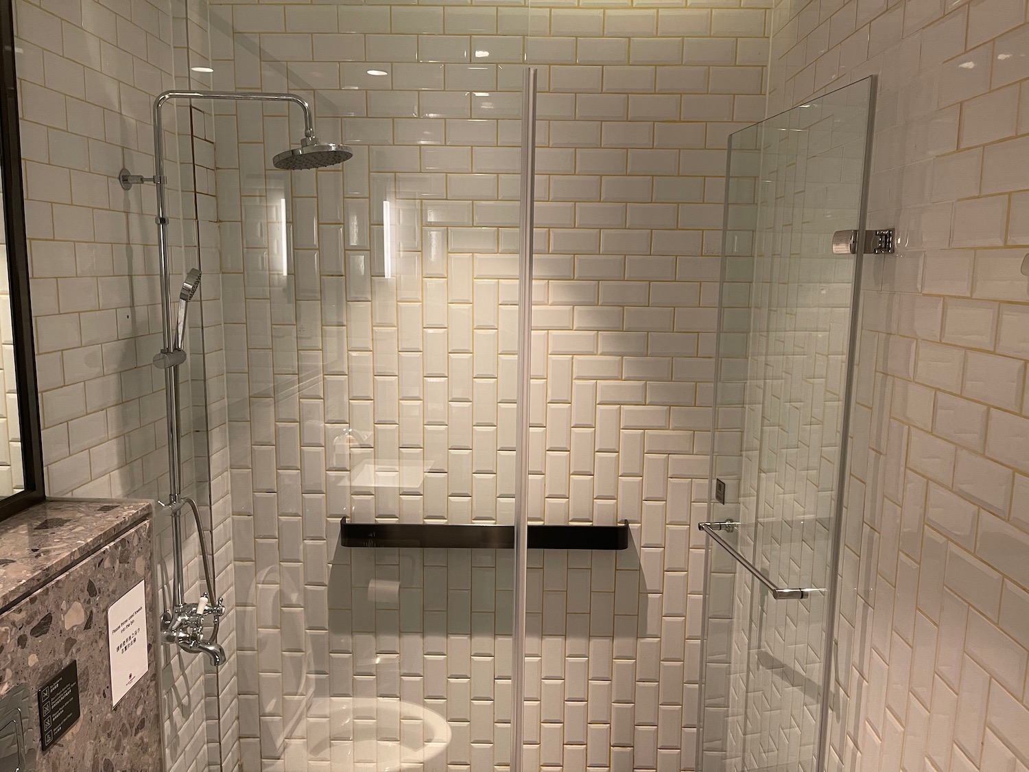 a shower with toilet and glass door