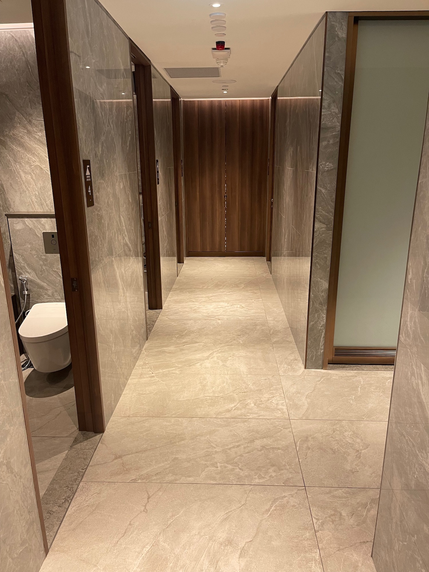 a bathroom with marble walls and doors