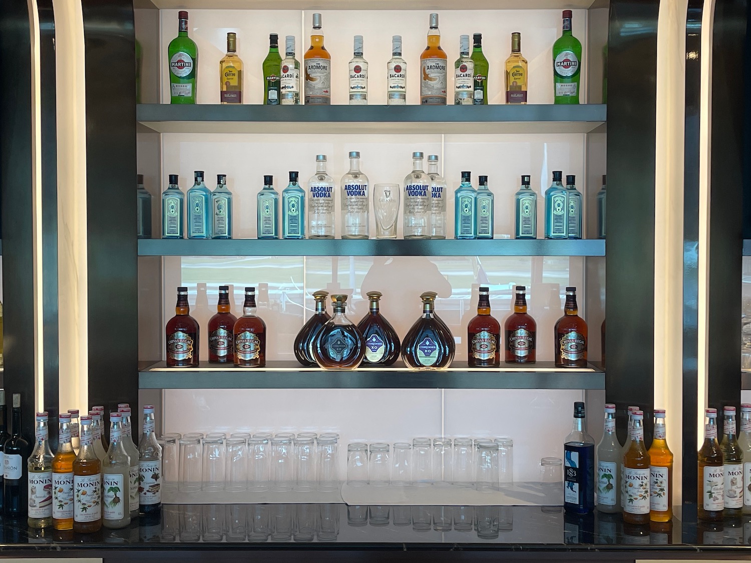 a shelf with bottles and glasses