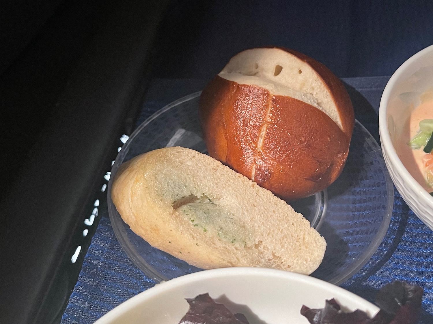 a roll and a loaf of bread on a plate