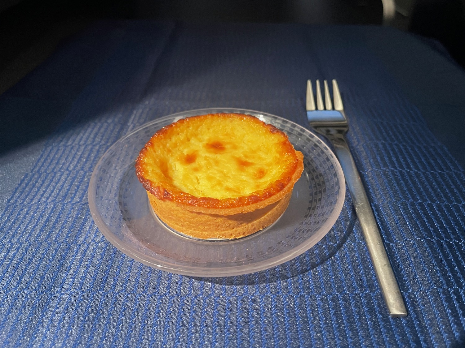 a small pastry on a plate with a fork