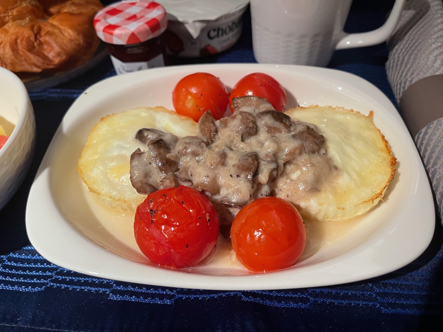 a plate of food with tomatoes and eggs