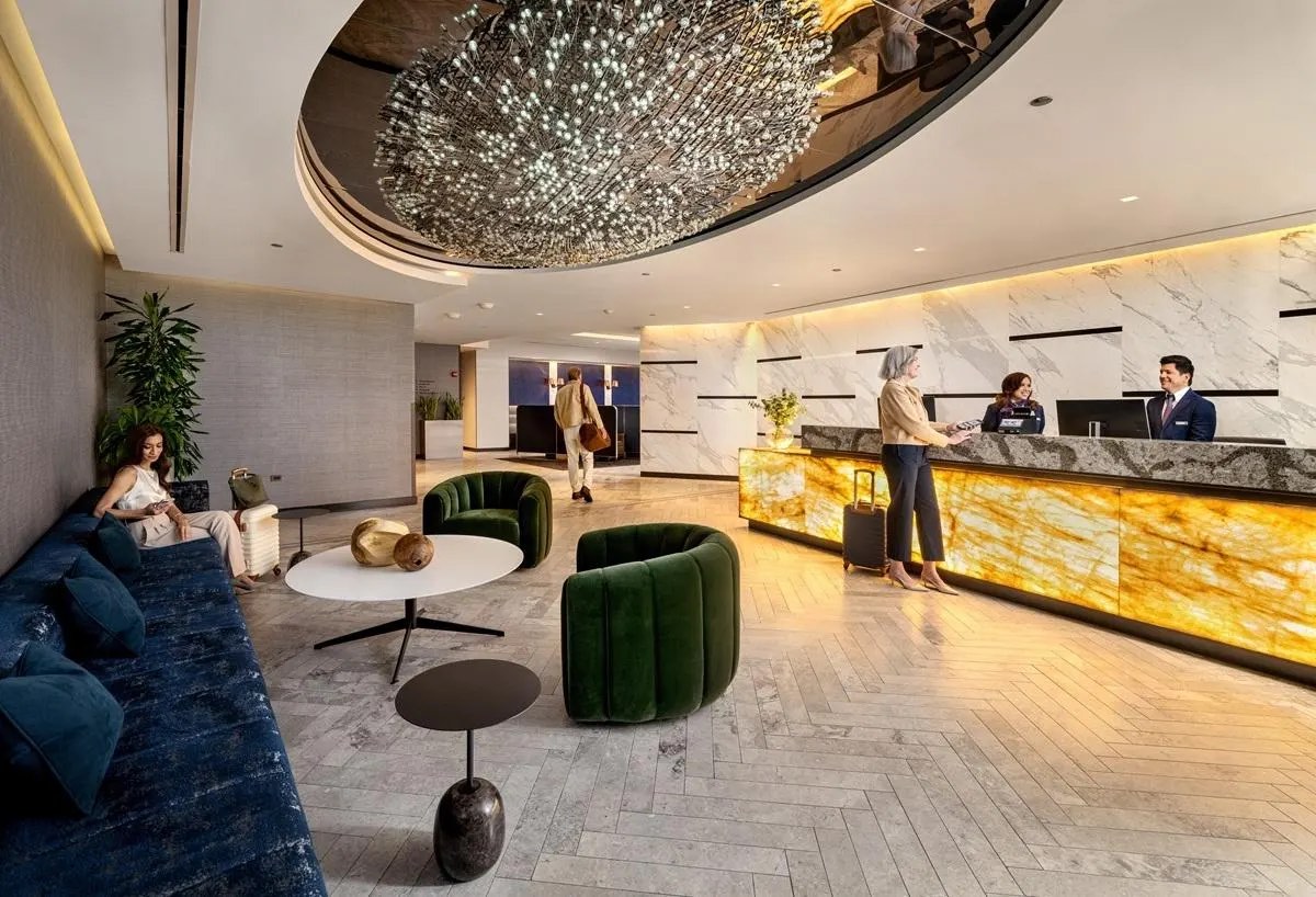a lobby with a chandelier and chairs