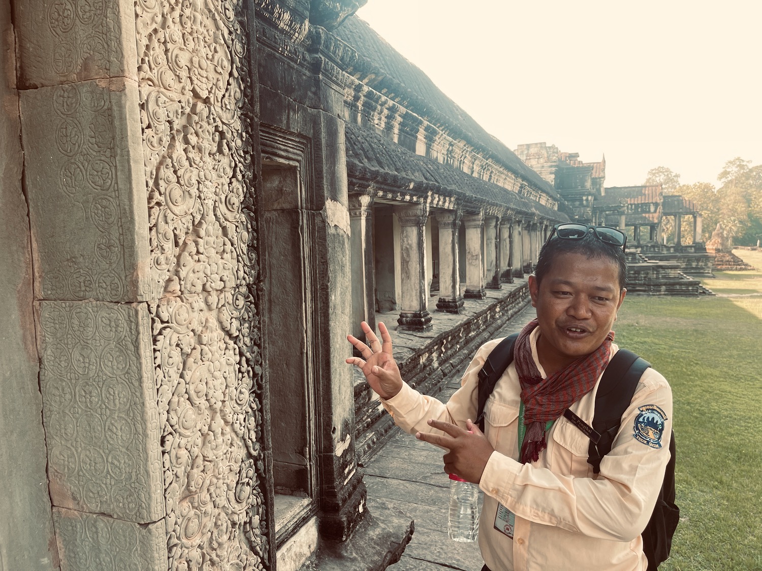 a man standing in front of a stone building