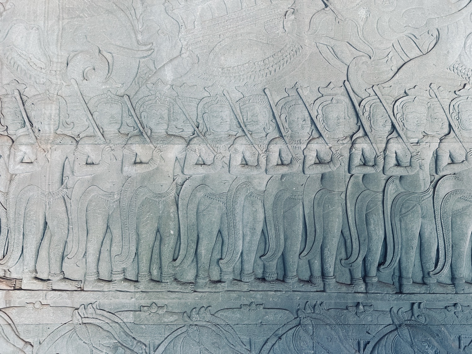 a stone carving of people in a row