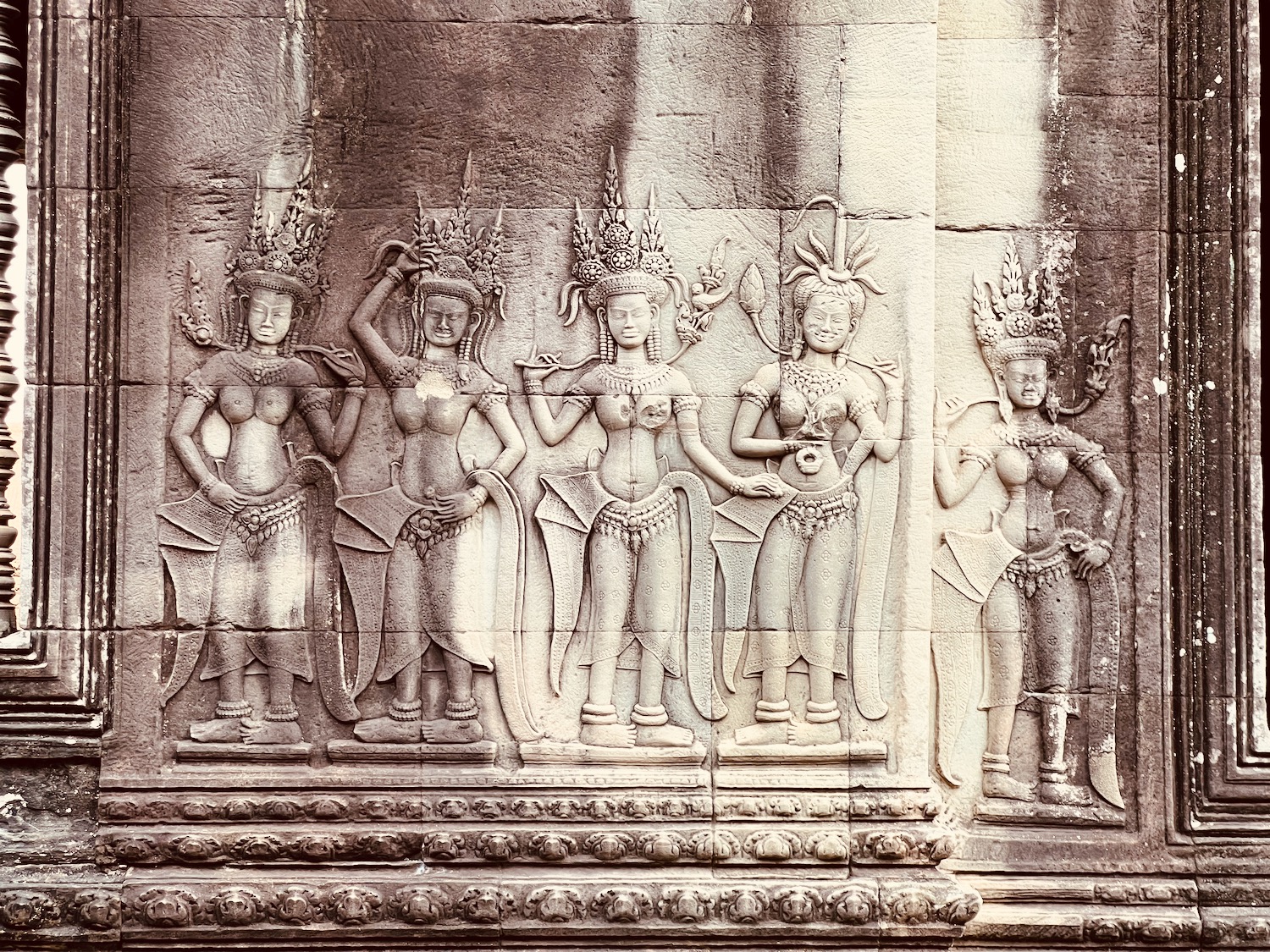 a stone carving of women in different poses