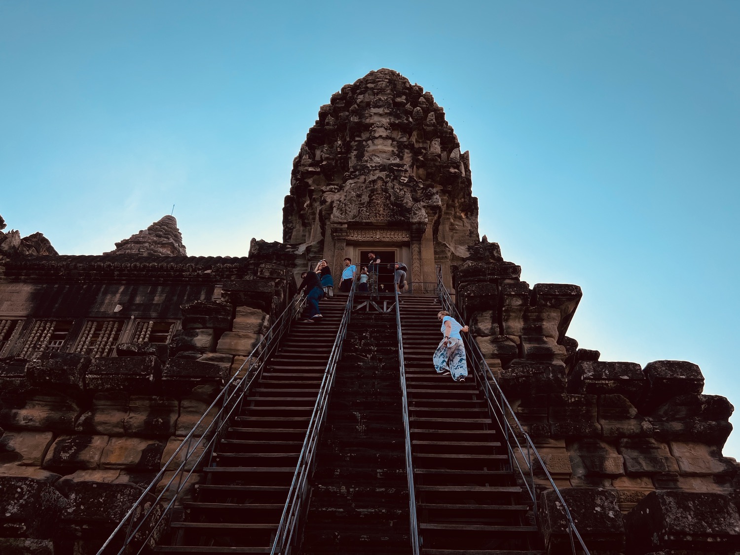 people walking up stairs to a building