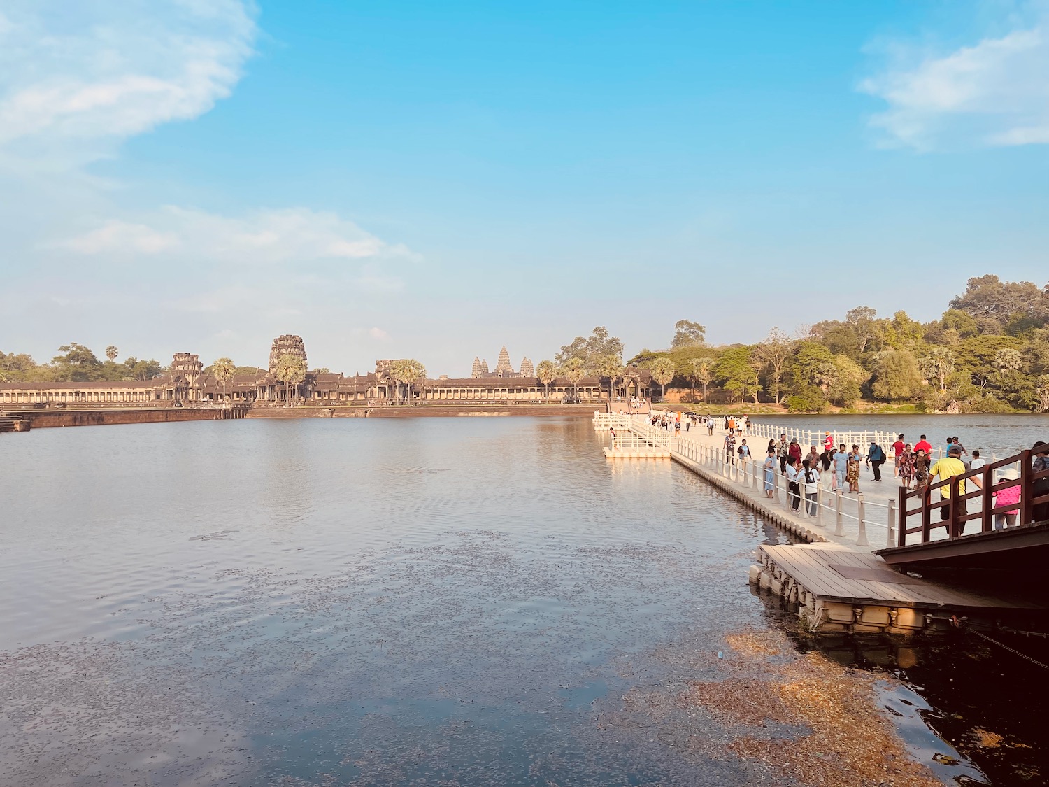 a group of people on a dock over a body of water