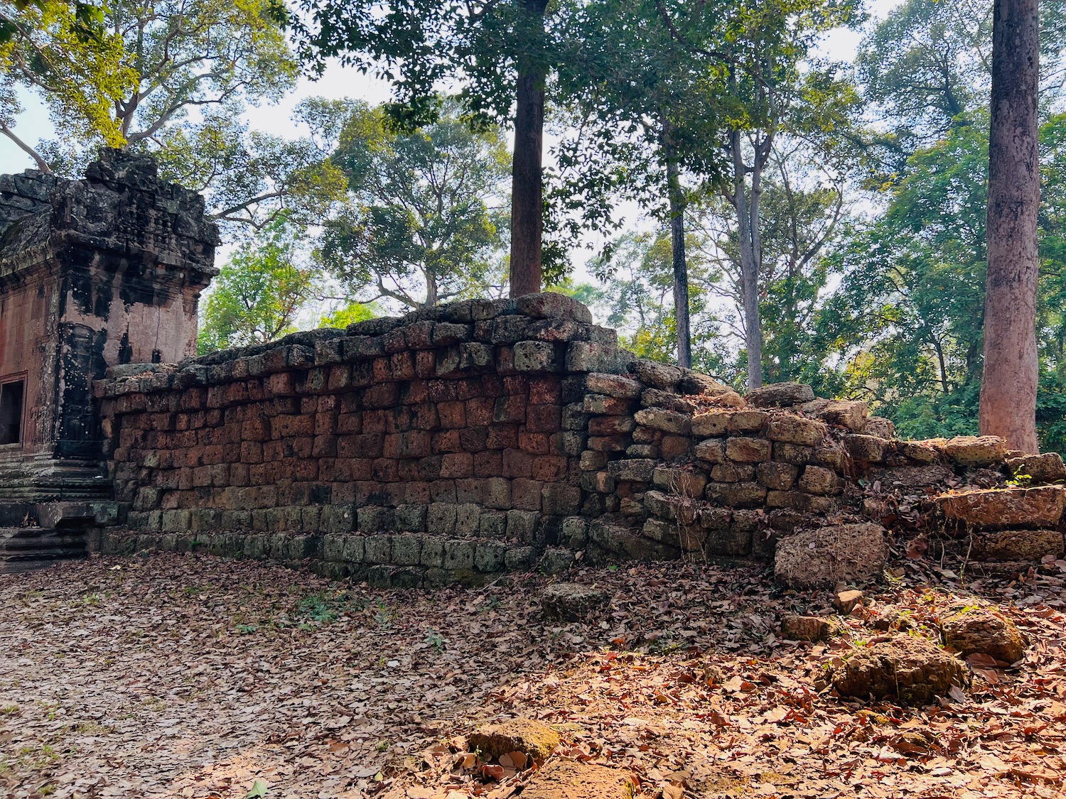 a stone wall with trees in the background