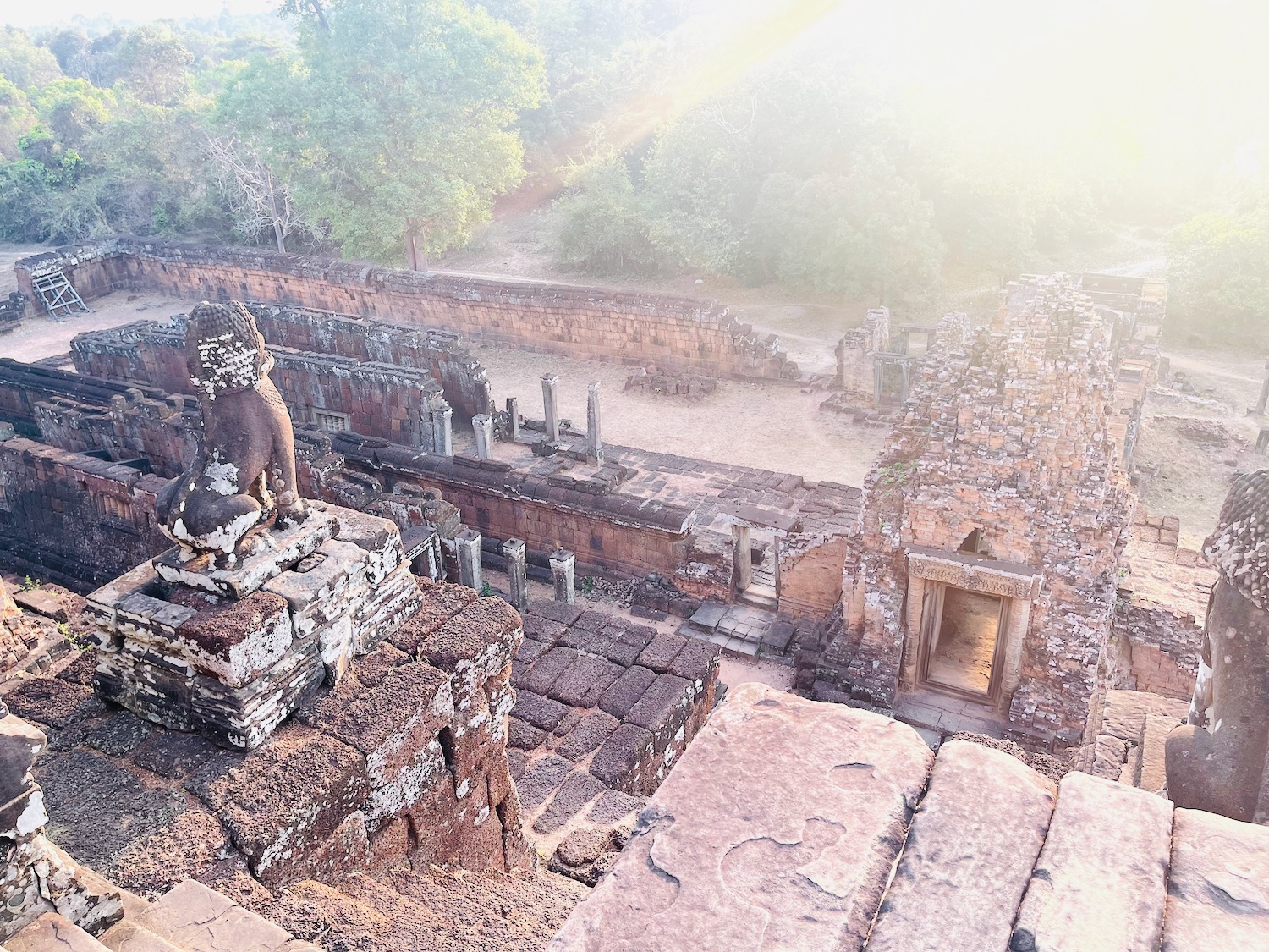 a stone ruins with a lion statue on top