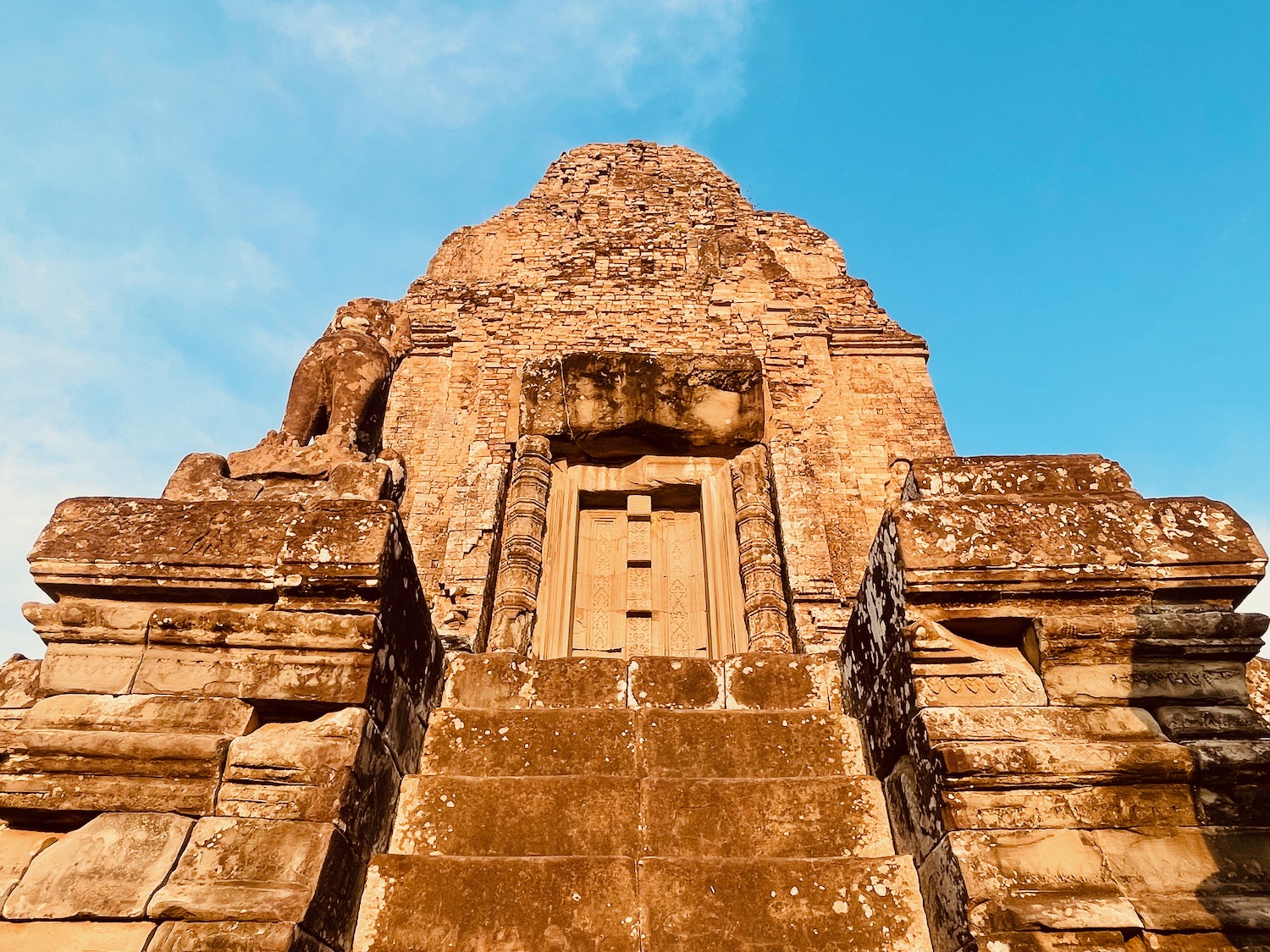 a stone building with a door and steps