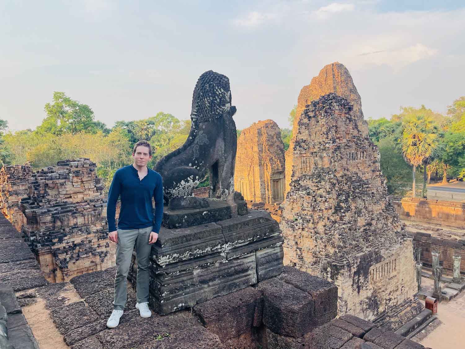 a man standing next to a statue