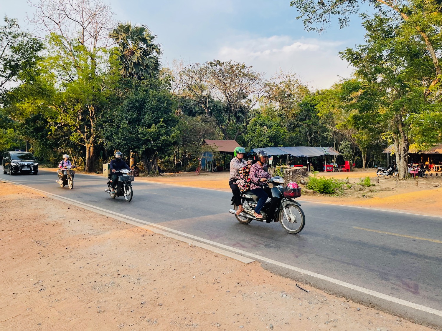 a group of people riding motorcycles on a road