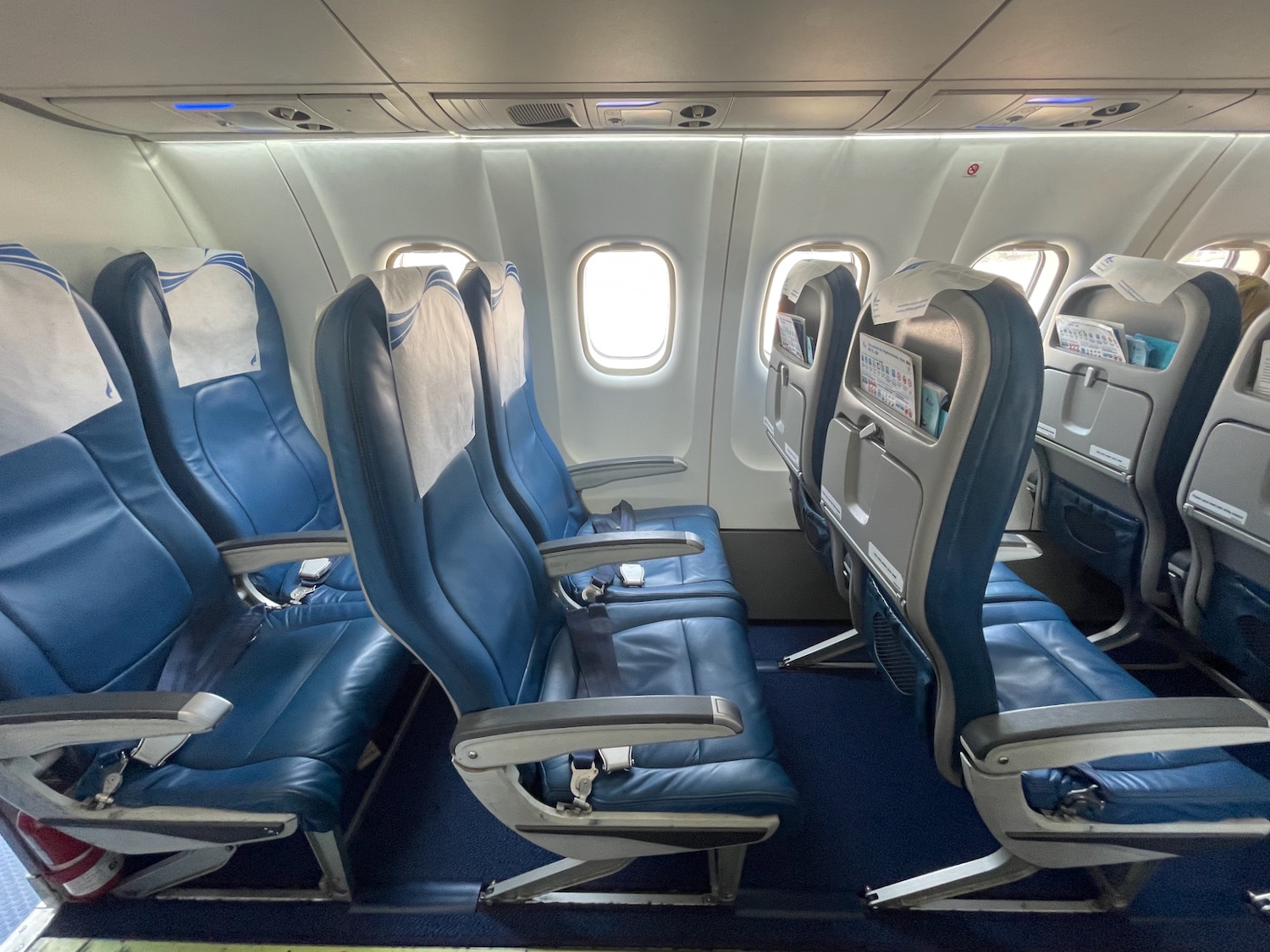 a row of blue seats in an airplane