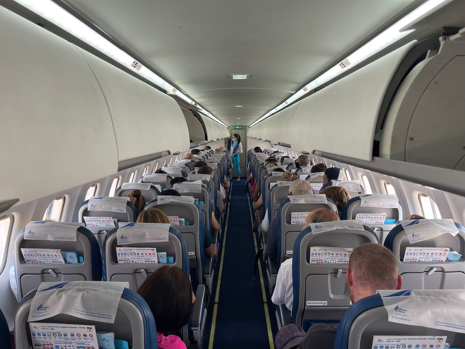 a group of people sitting in an airplane