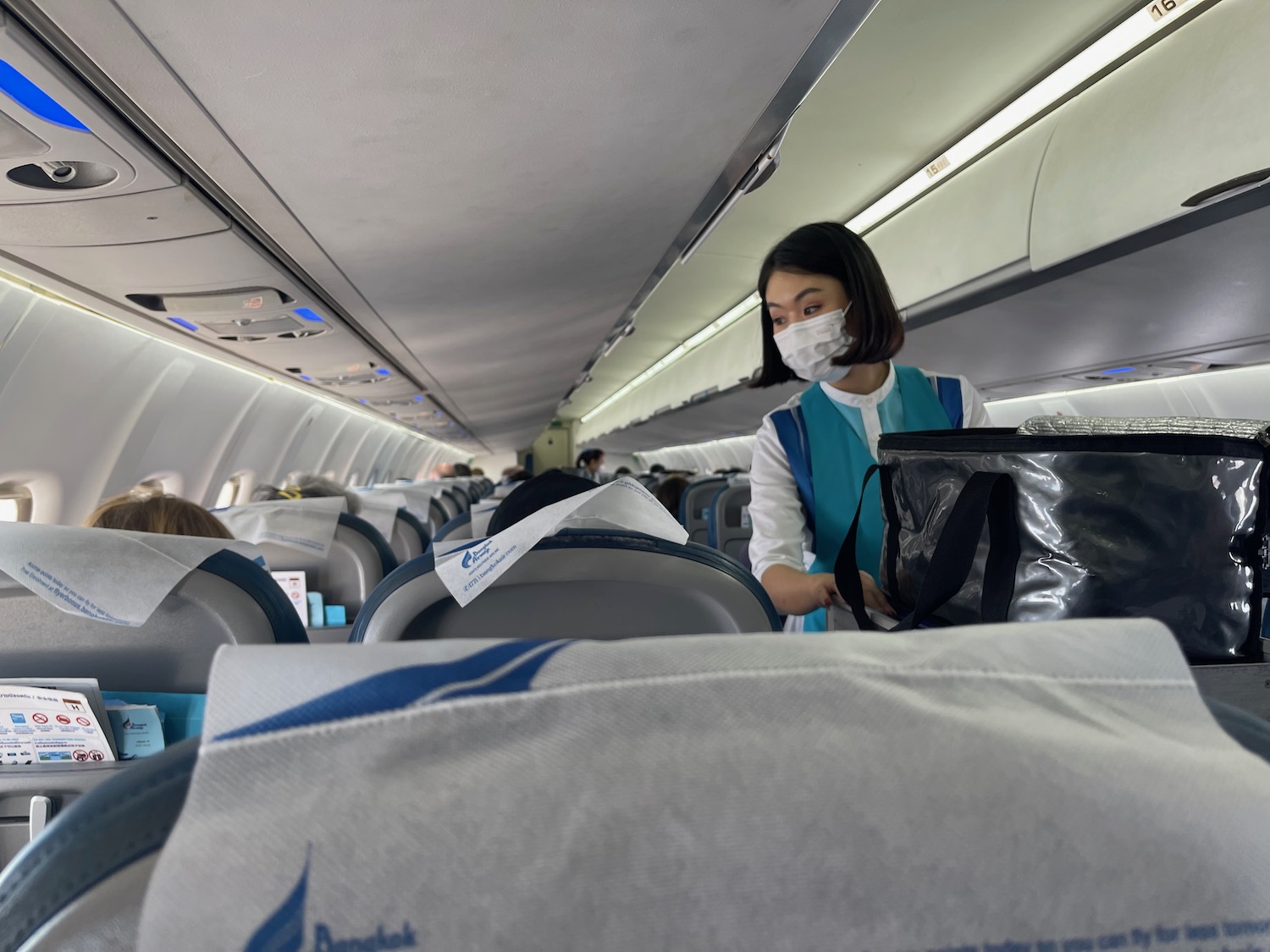 a woman wearing a mask on an airplane