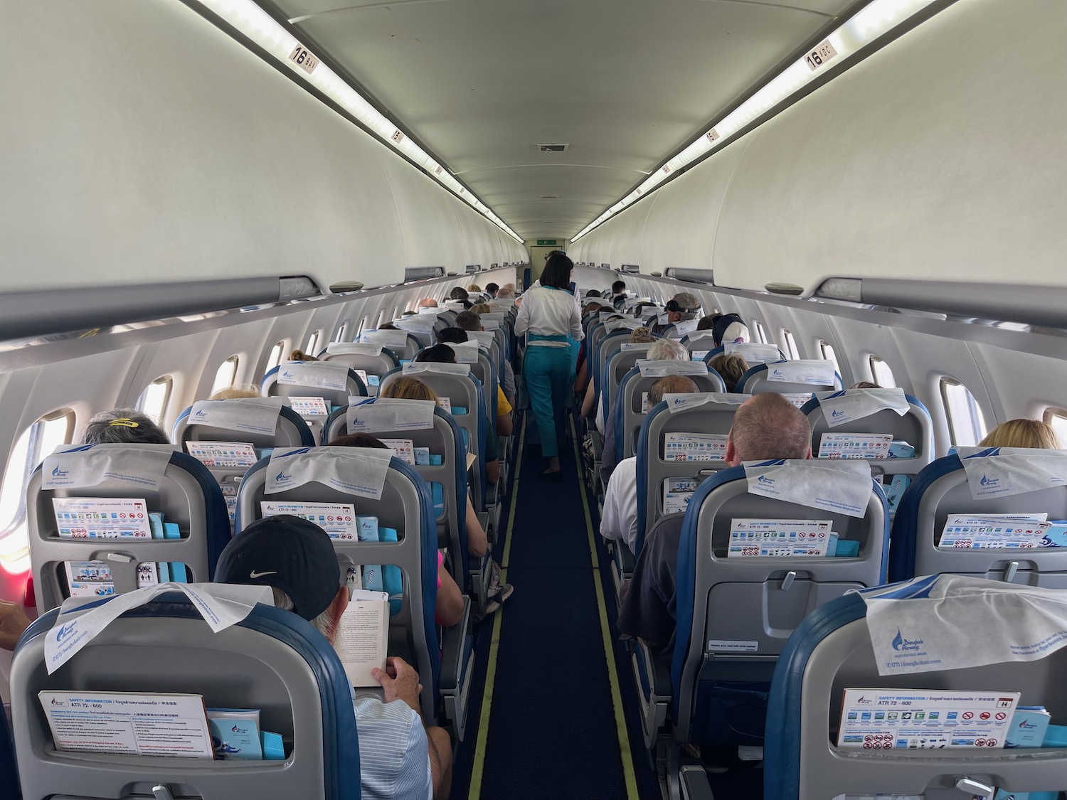 a group of people sitting in an airplane