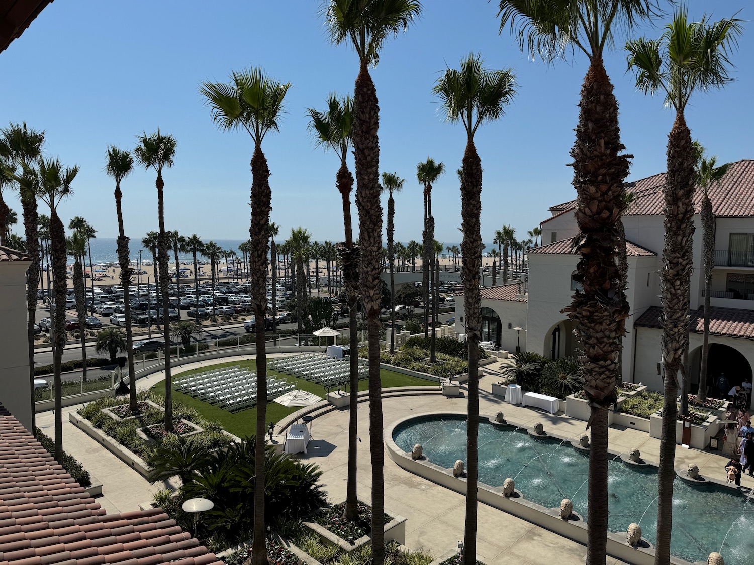 a large building with palm trees and a pool