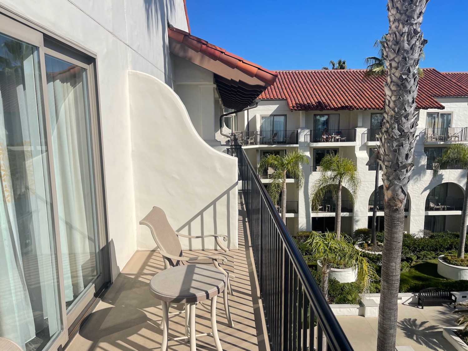 a balcony with chairs and a table