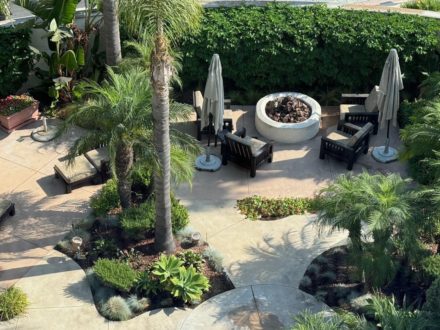 a patio with chairs and a fire pit